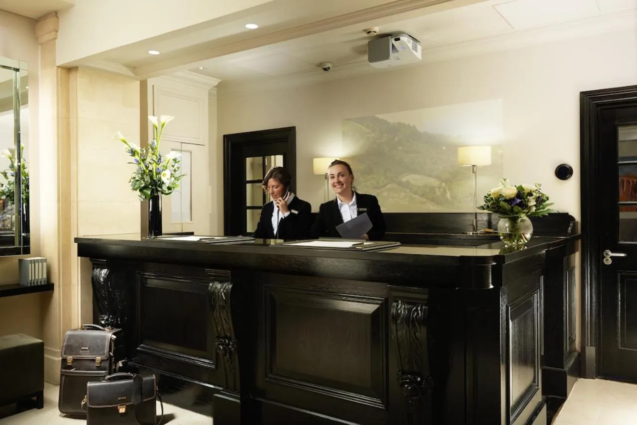 Guests working at a desk in a room at London Bridge Hotel, Southwark