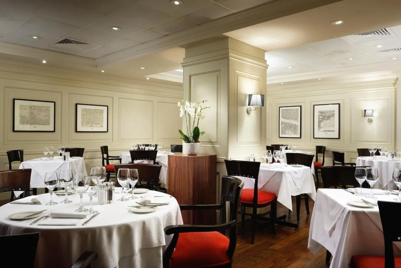 Londinium restaurant with white tablecloths at London Bridge Hotel, London